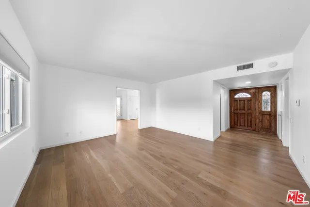 a view of a patio with couches table and chairs and potted plants