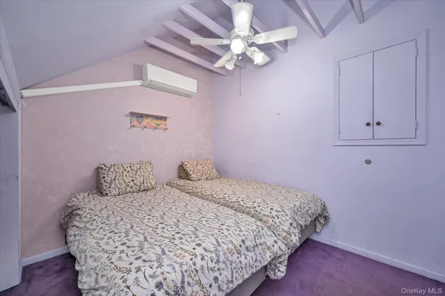 a bedroom with a bed chandelier and a window