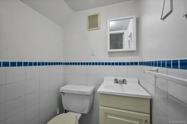 a bathroom with a sink a toilet and mirror