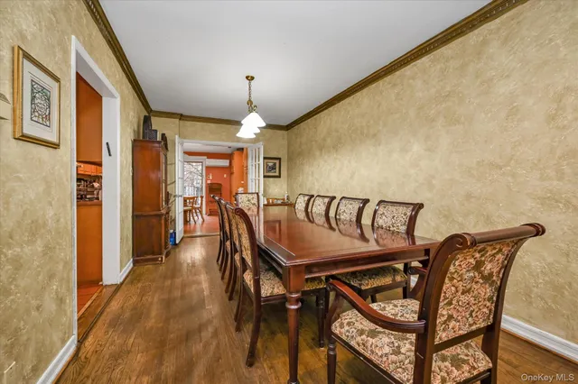 a view of a hallway with furniture and wooden floor