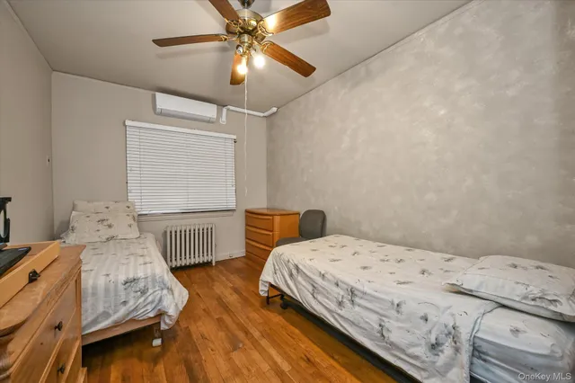 a bedroom with a bed and ceiling fan