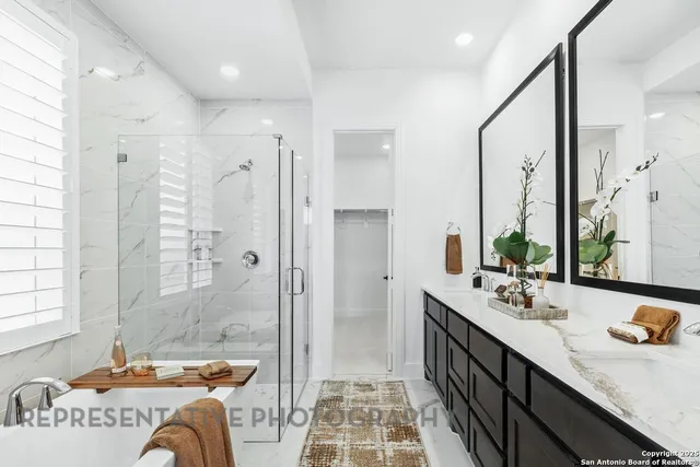 a spacious bathroom with a double vanity sink mirror and double