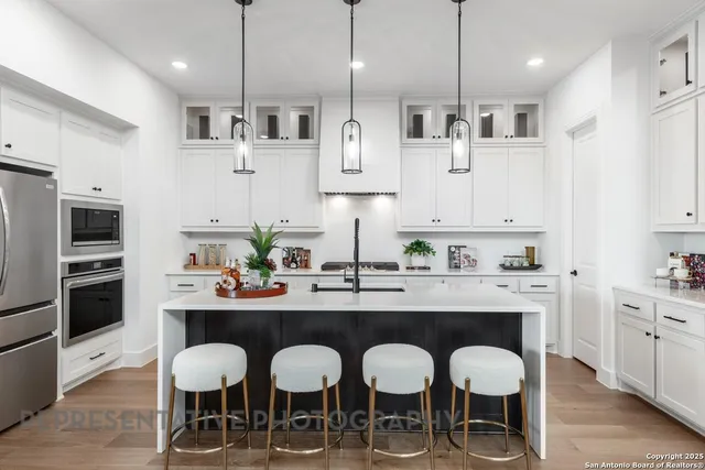 a kitchen with stainless steel appliances a sink and stove