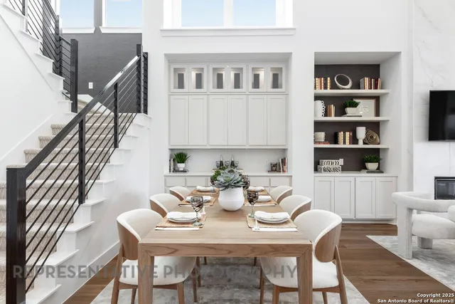 a view of a dining room with furniture and a potted plant
