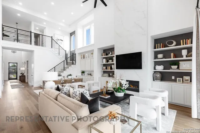 a living room with furniture a flat screen tv and a floor to ceiling window