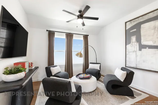 a living room with furniture a potted plant and a window