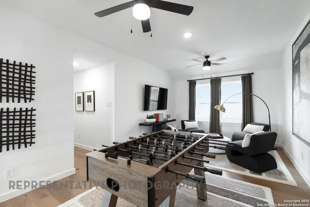 a living room with furniture and wooden floor
