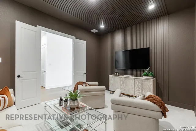 a living room with furniture a flat screen tv and a fireplace