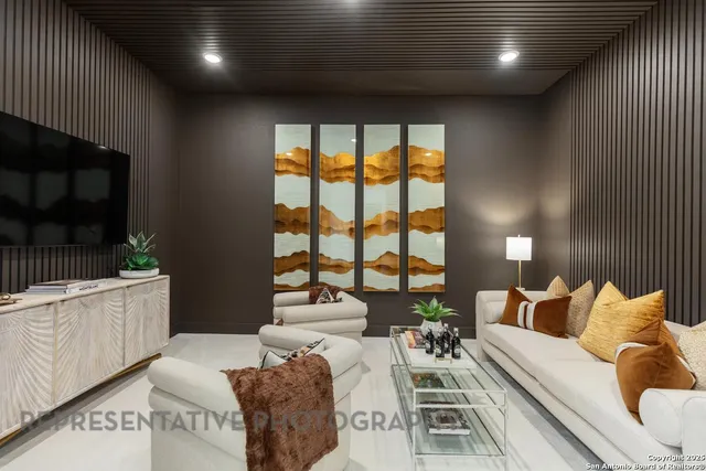 a living room with furniture and a floor to ceiling window