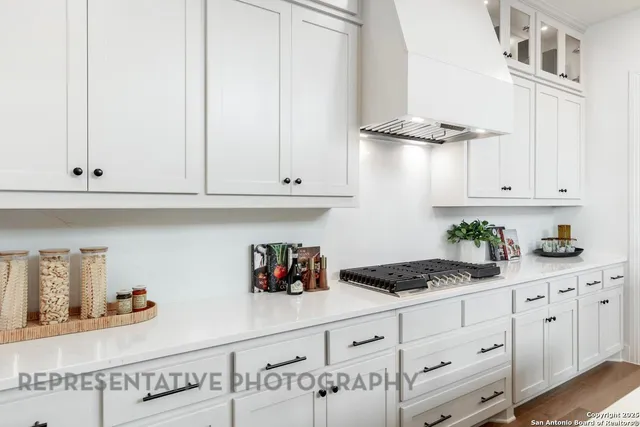 a kitchen with white cabinets and white appliances