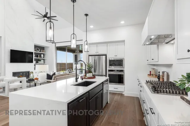 a kitchen with kitchen island a sink stainless steel appliances and cabinets