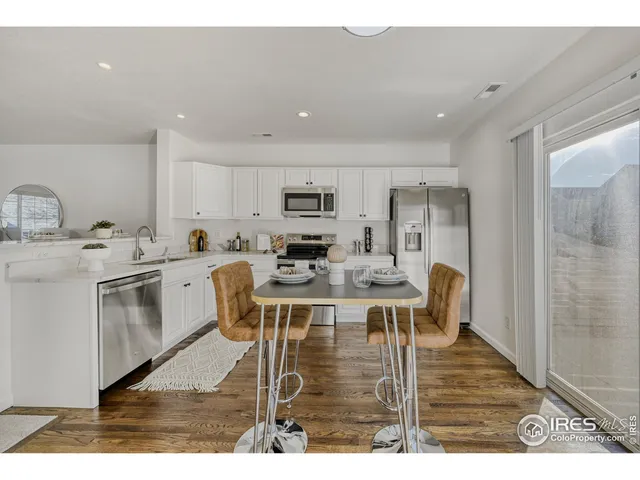 a kitchen with stainless steel appliances kitchen island granite countertop a sink and cabinets