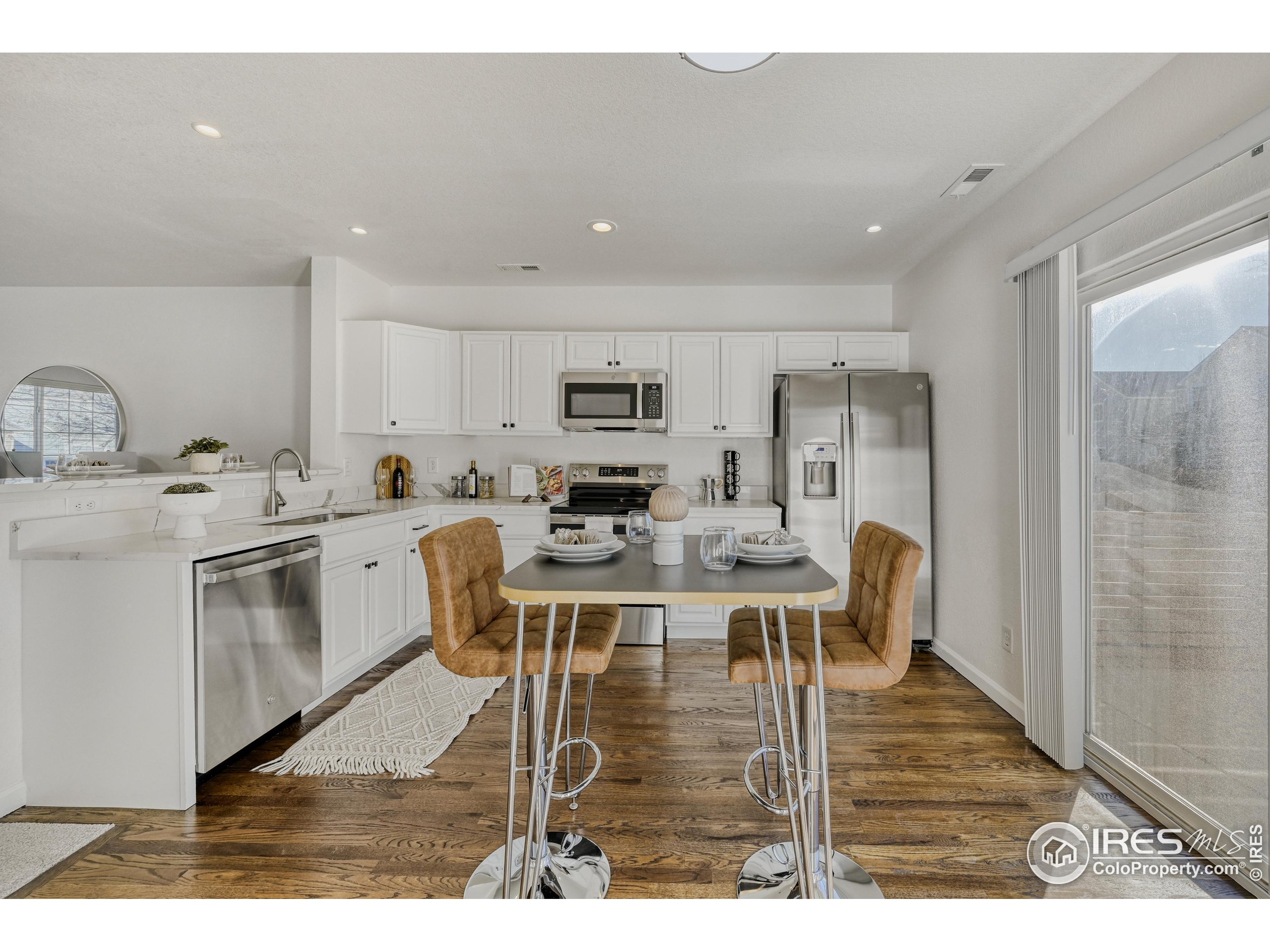 6130 Gorham Street Frederick, CO 80530 - Photo 11 of 48 a kitchen with stainless steel appliances kitchen island granite countertop a sink and cabinets
