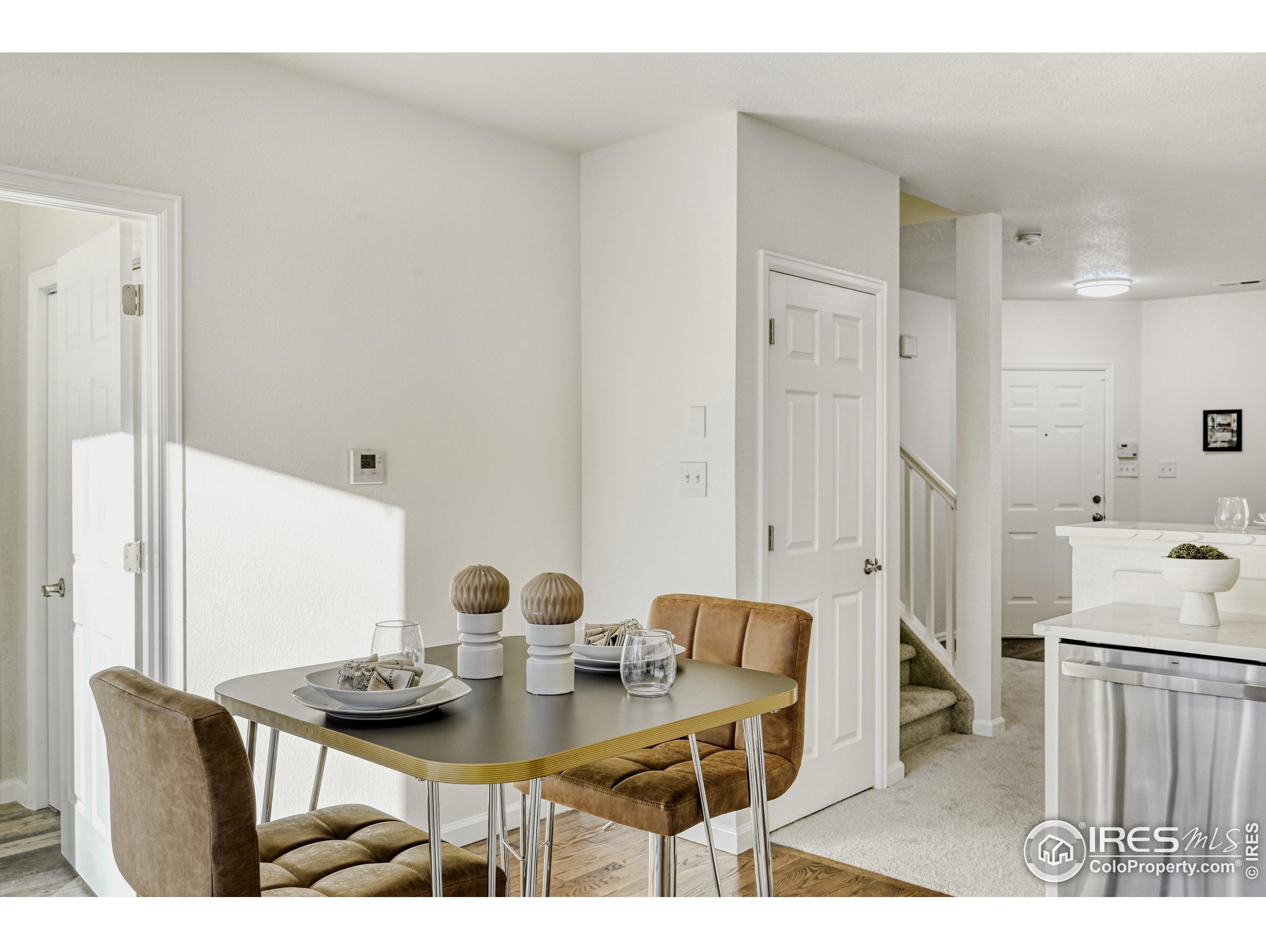 6130 Gorham Street Frederick, CO 80530 - Photo 12 of 48 a view of a dining room with furniture and wooden floor