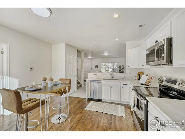 a kitchen with a sink cabinets and wooden floor