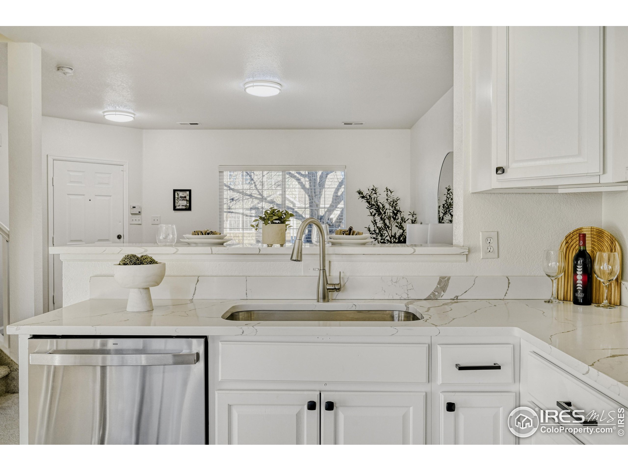 6130 Gorham Street Frederick, CO 80530 - Photo 17 of 48 a kitchen with kitchen island granite countertop a sink and cabinets