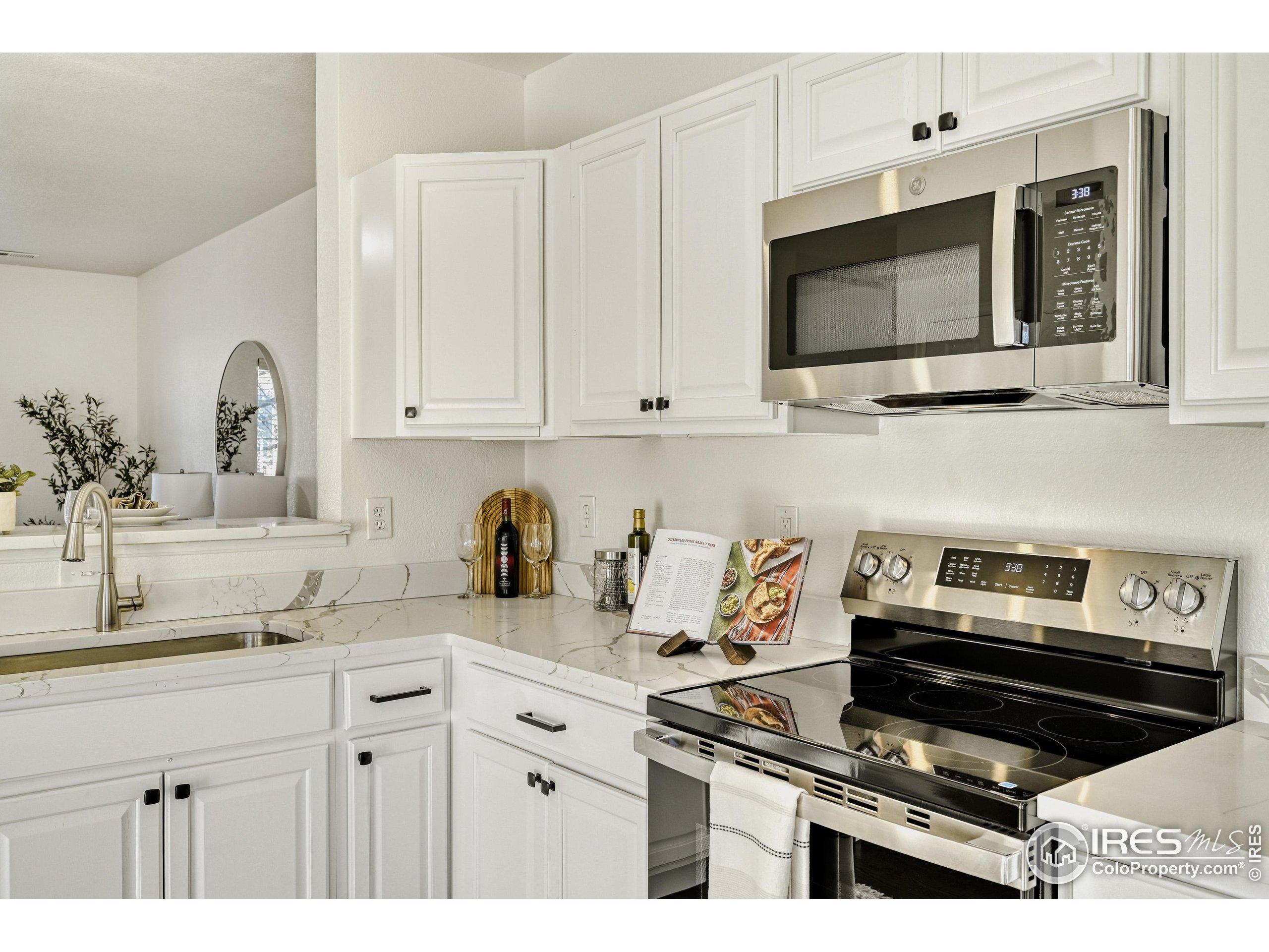 6130 Gorham Street Frederick, CO 80530 - Photo 18 of 48 a kitchen with appliances a sink and cabinets