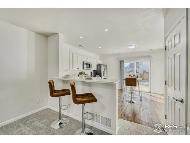a living room with furniture and kitchen view