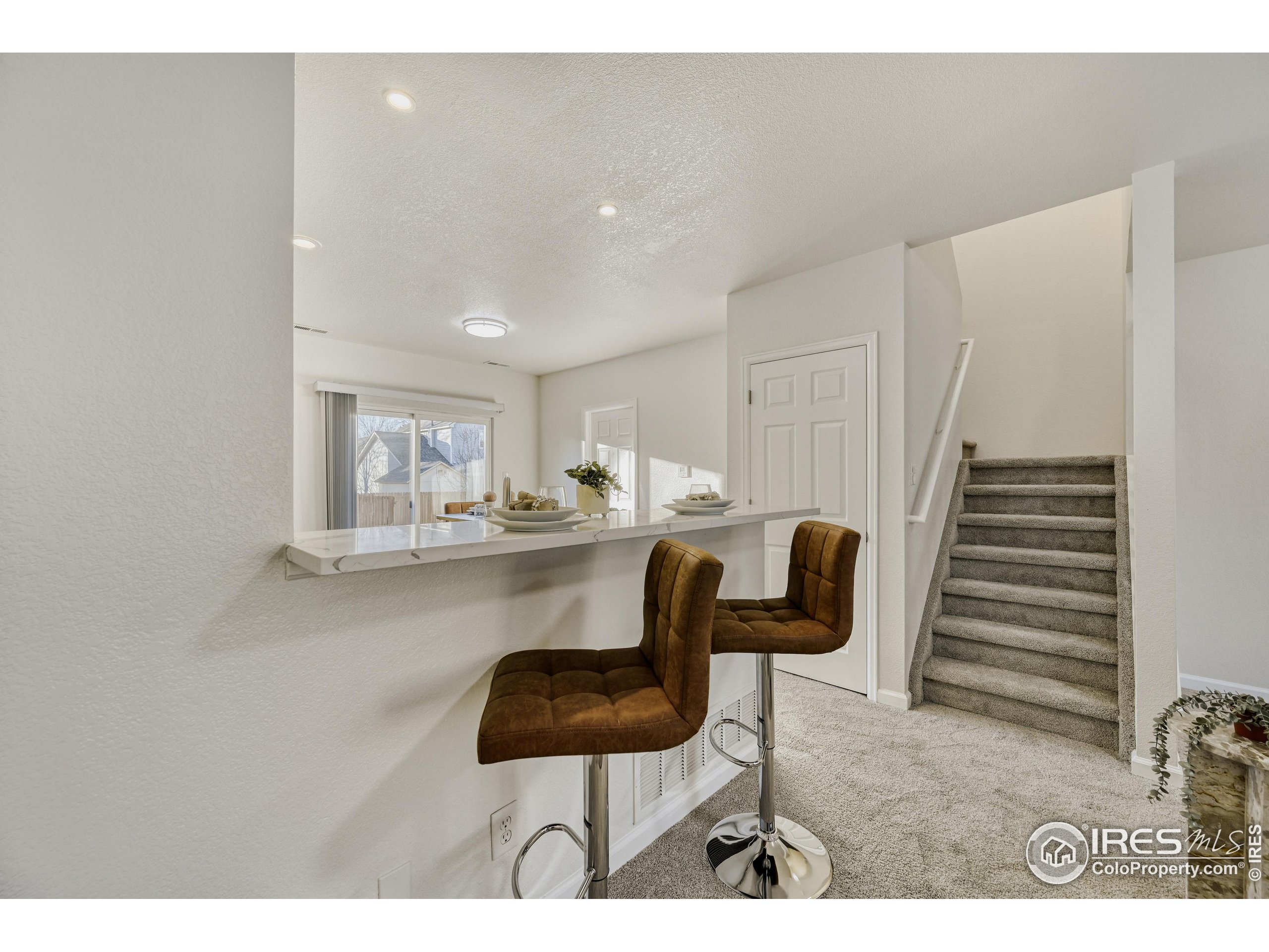 6130 Gorham Street Frederick, CO 80530 - Photo 22 of 48 a kitchen with a table and chairs