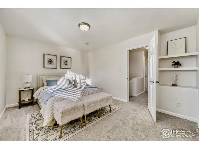 a bedroom with a bed and a lamp