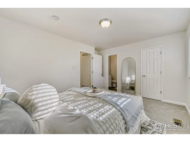 a bedroom with a bed and a lamp