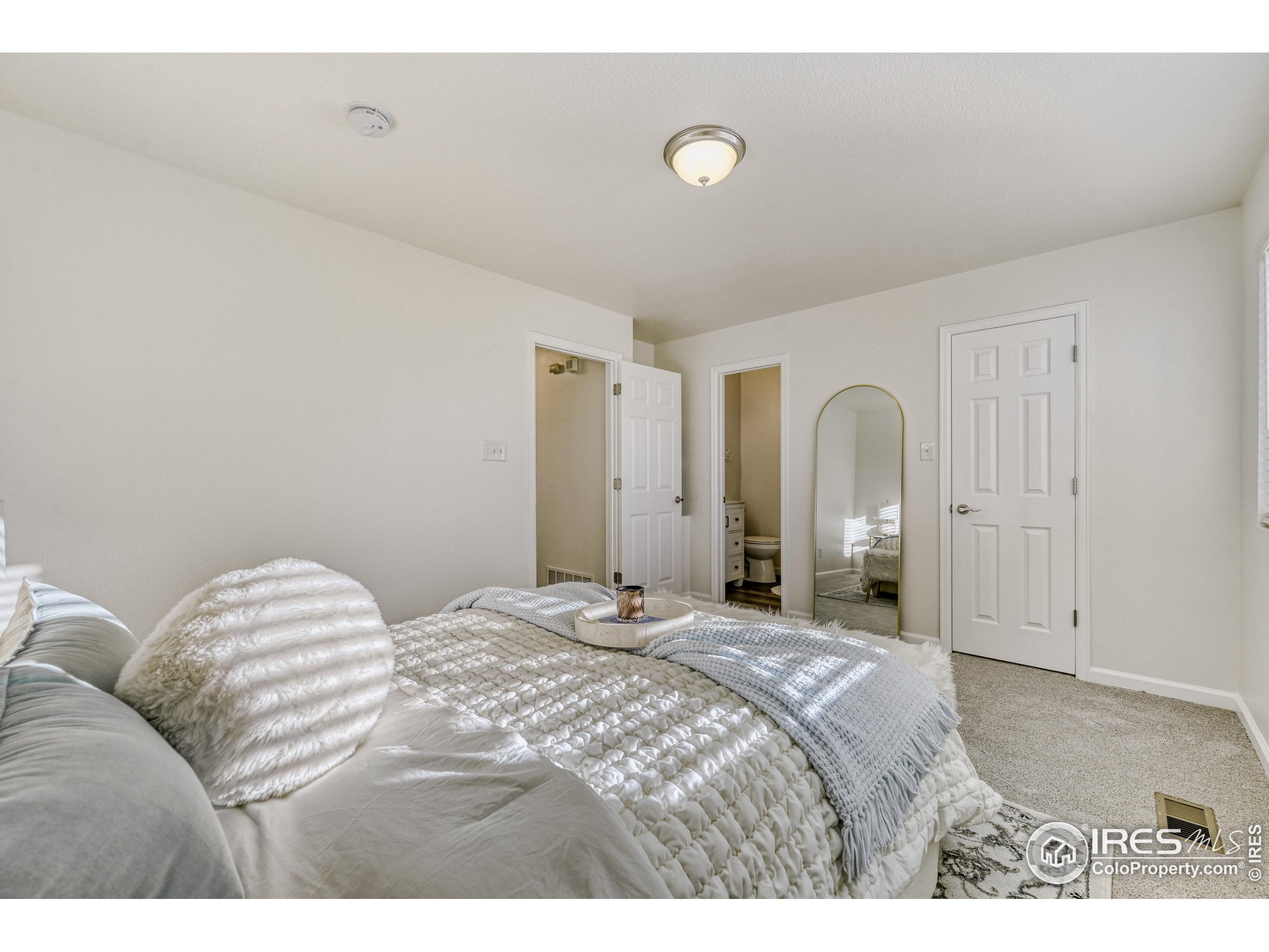 6130 Gorham Street Frederick, CO 80530 - Photo 27 of 48 a bedroom with a bed and a lamp