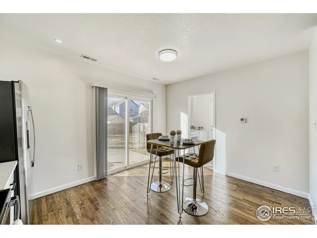 a dining room with furniture and wooden floor