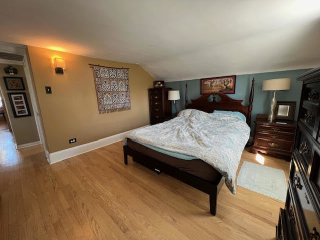 1533 Dempster Street Evanston, IL 60201 - Photo 17 of 27 a bedroom with a bed and wooden floor
