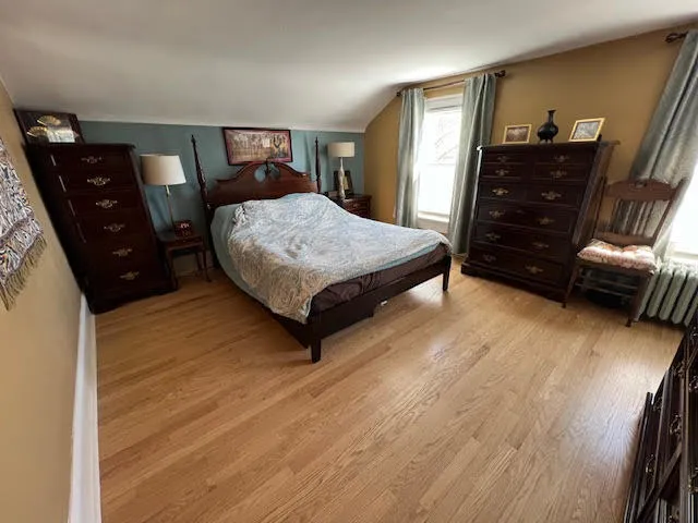 a bedroom with furniture and a book shelf
