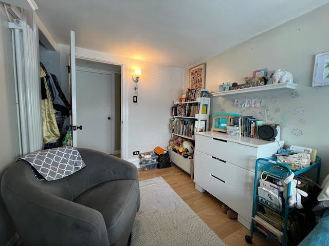 1533 Dempster Street Evanston, IL 60201 - Photo 19 of 27 a bedroom with furniture and a book shelf