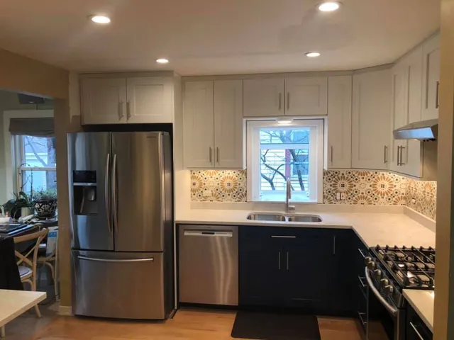 a kitchen with stainless steel appliances granite countertop a refrigerator and a sink