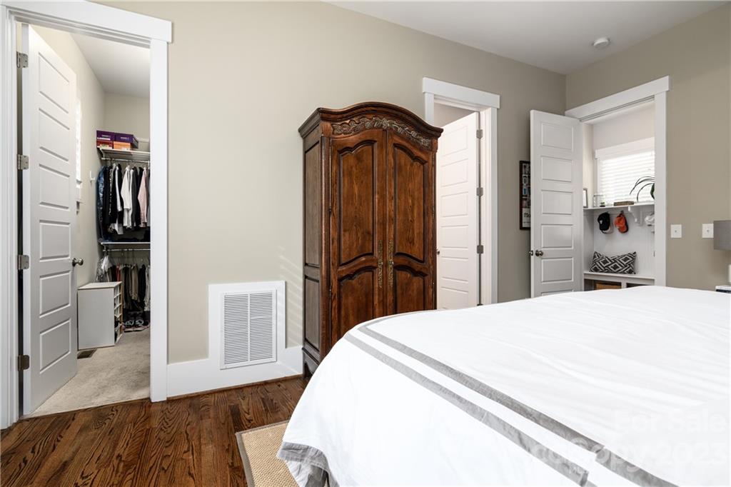 205 Coneflower Place Fort Mill, SC 29708 - Photo 13 of 38 a bedroom with a bed and wooden floor