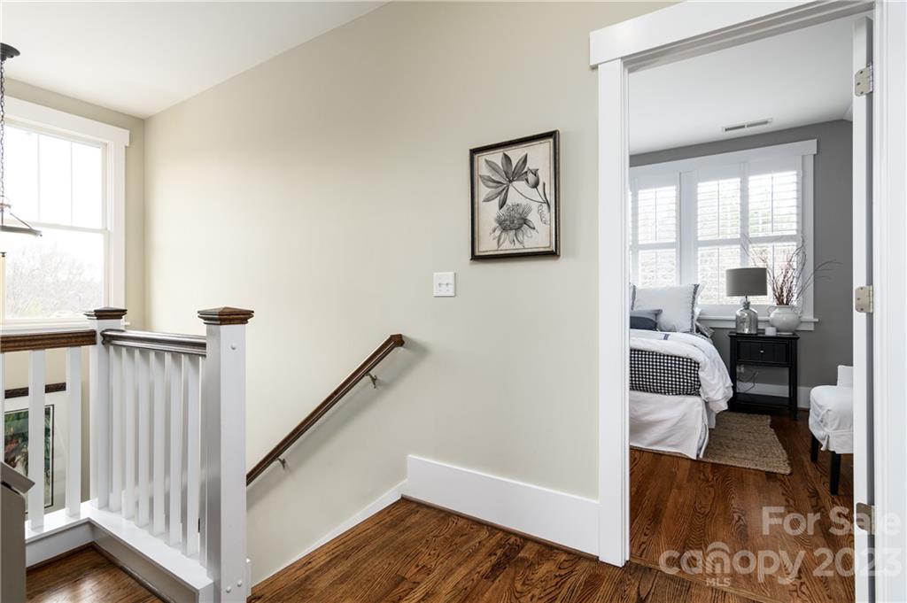 205 Coneflower Place Fort Mill, SC 29708 - Photo 17 of 38 a view of a bedroom with wooden floor and furniture
