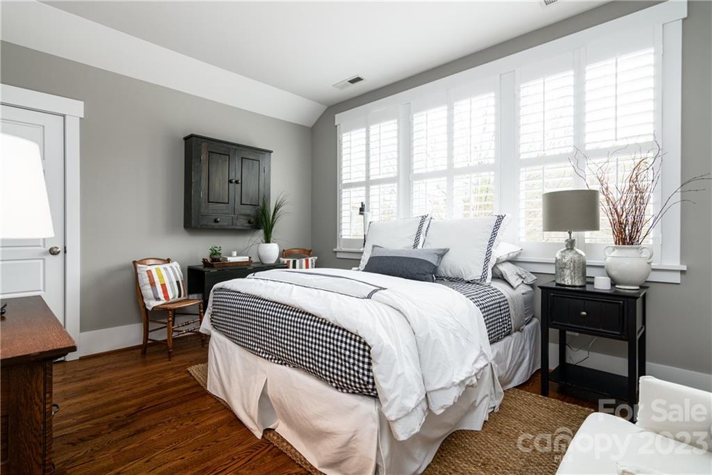205 Coneflower Place Fort Mill, SC 29708 - Photo 18 of 38 a bedroom with a bed and wooden floor