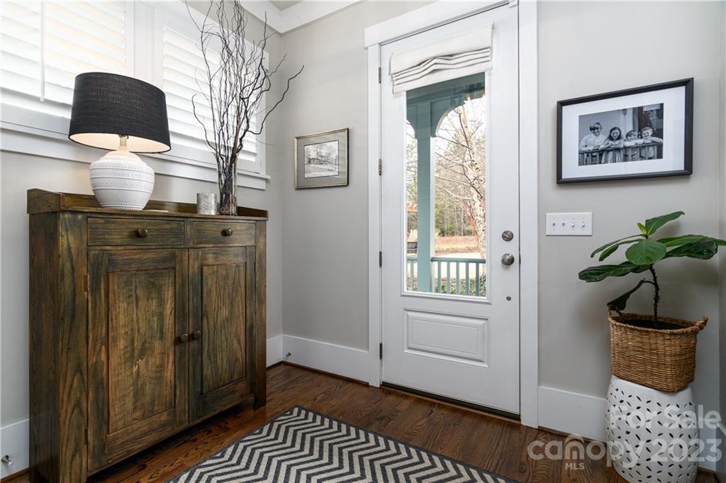 205 Coneflower Place Fort Mill, SC 29708 - Photo 4 of 38 a view of a hallway with wooden floor windows and cabinet