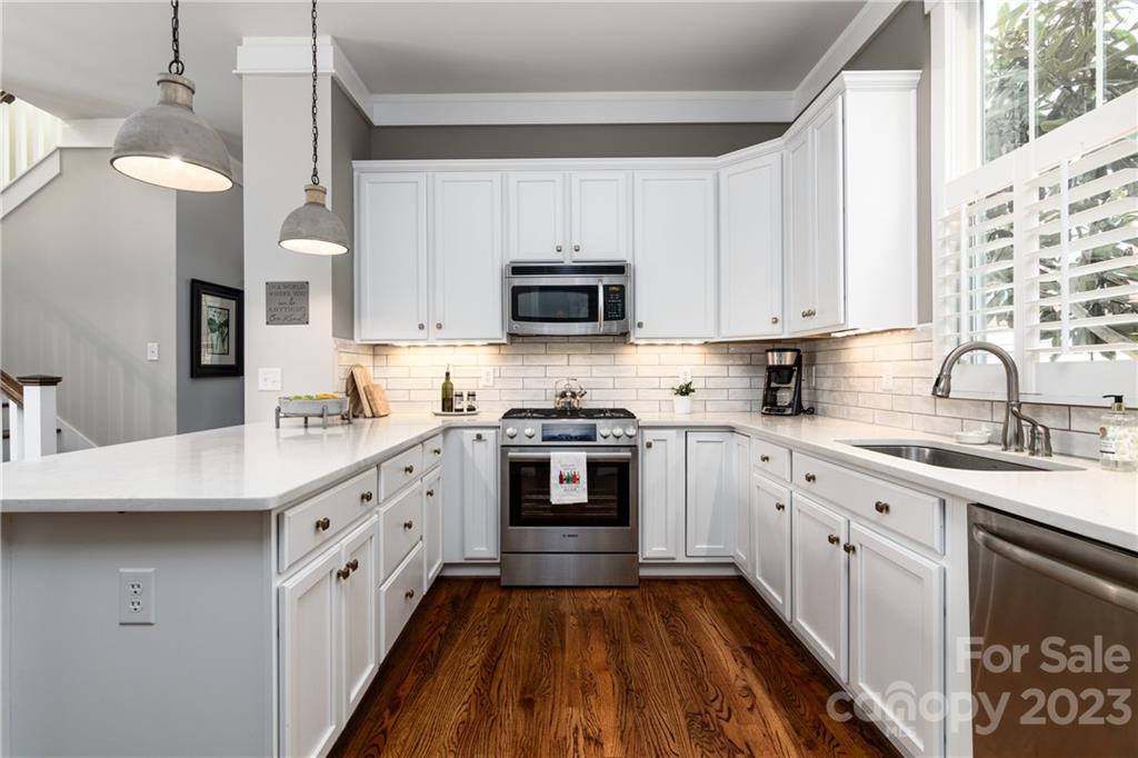 205 Coneflower Place Fort Mill, SC 29708 - Photo 10 of 38 a kitchen with stainless steel appliances granite countertop a stove sink and cabinets