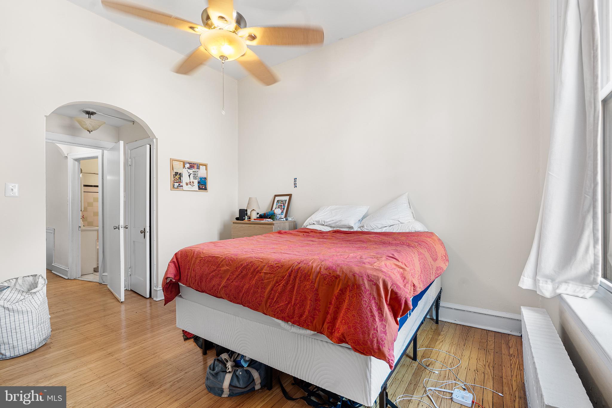 1712 Pine Street Philadelphia, PA 19103 - Photo 16 of 33 a spacious bedroom with a bed and a chandelier