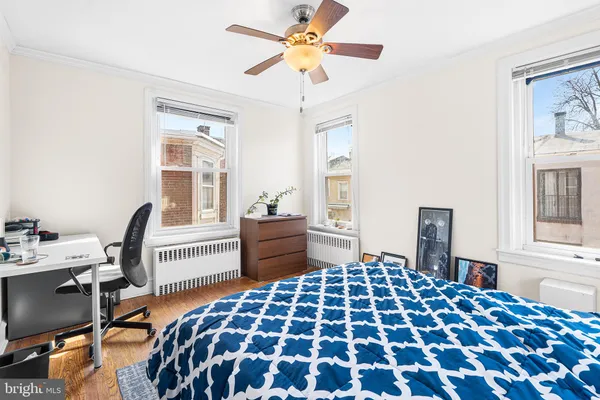 a bedroom with a bed and a desk