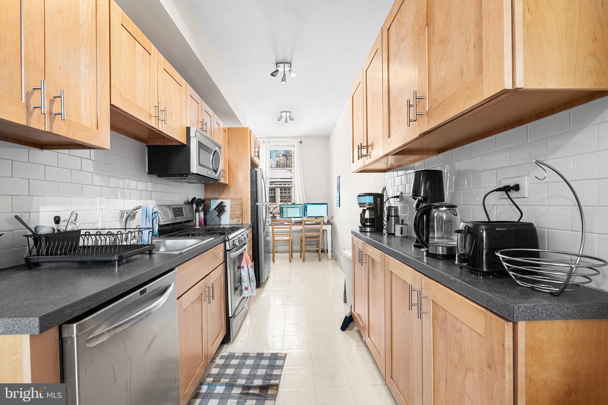 1712 Pine Street Philadelphia, PA 19103 - Photo 22 of 33 a kitchen with stainless steel appliances a sink a stove and cabinets