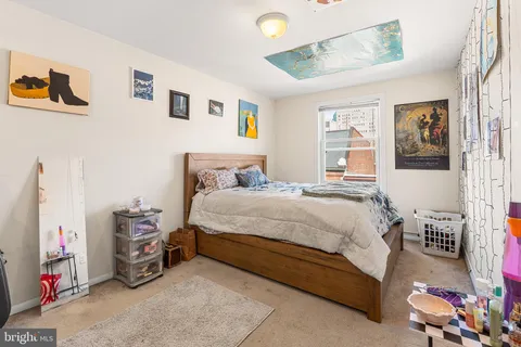 a bedroom with a bed and a couch