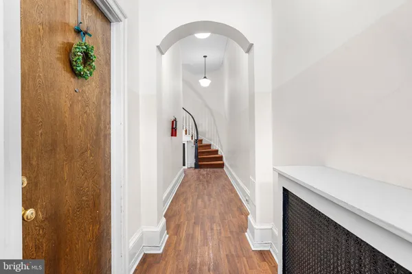 a view of a hallway with wooden floor and staircase