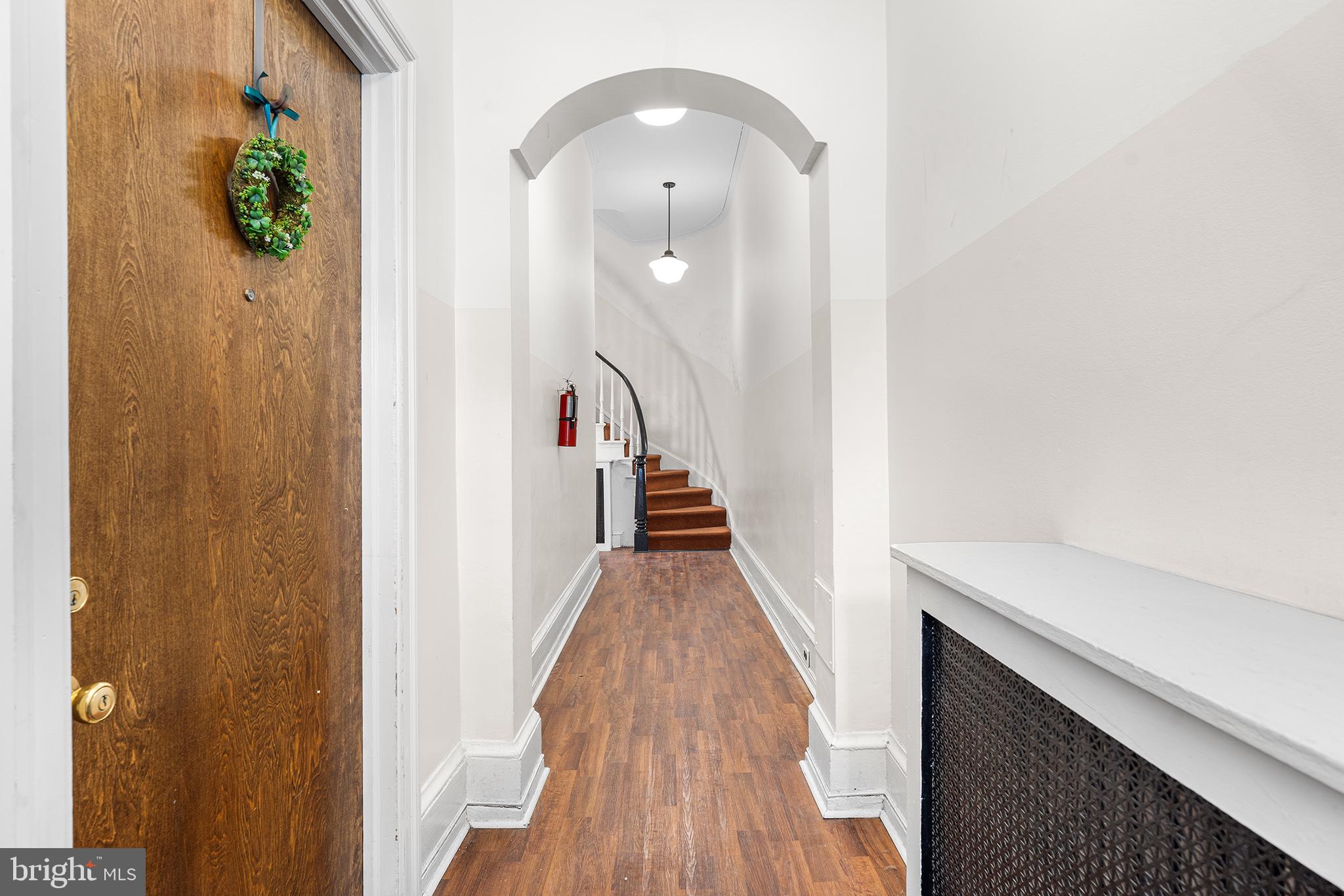 1712 Pine Street Philadelphia, PA 19103 - Photo 3 of 33 a view of a hallway with wooden floor and staircase