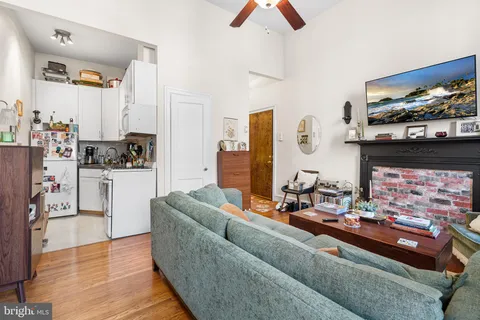 a living room with furniture and a fireplace