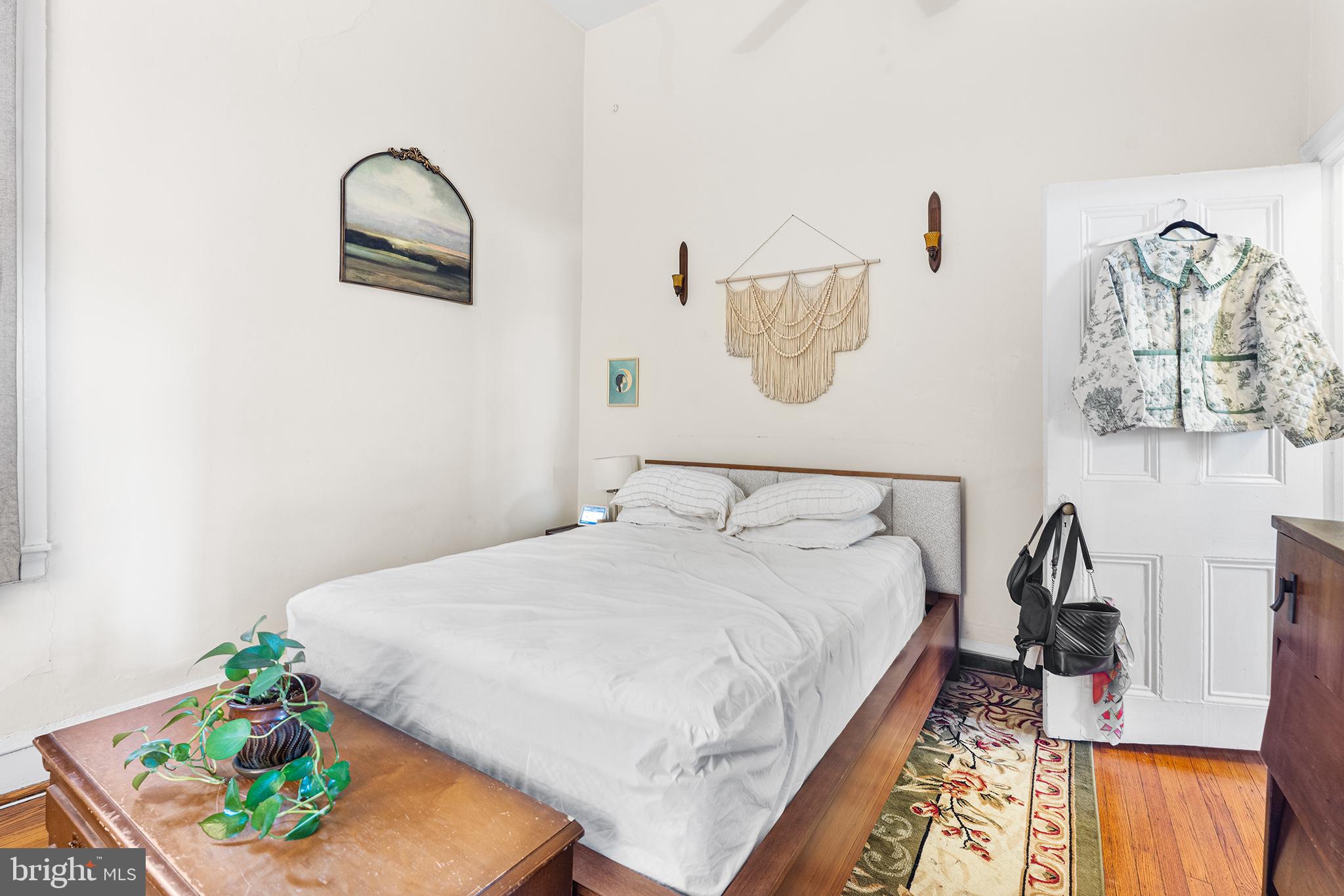 1712 Pine Street Philadelphia, PA 19103 - Photo 6 of 33 a bedroom with a bed and a painting on the wall