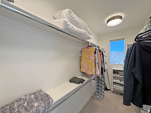 851 Grandview Drive Morgan, UT 84050 - Photo 23 of 68 Walk-in closet featuring built-in shelving, chrome hanging rods, recessed lighting, and a window with mountain scenery