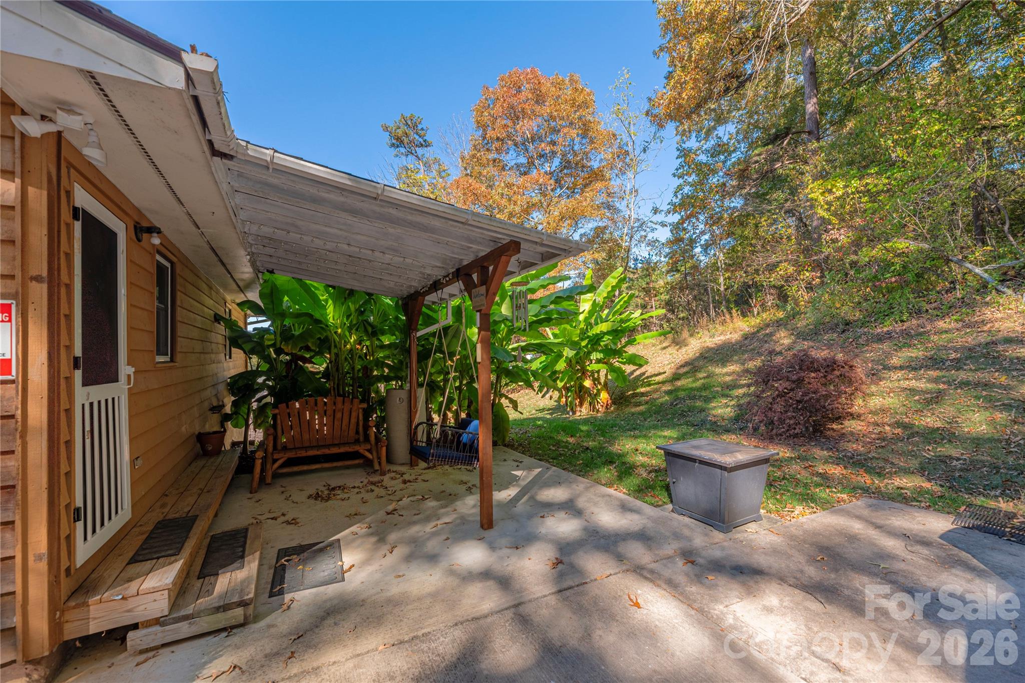 29 Arrowhead Street Clyde, NC 28721 - Photo 15 of 18 a view of a patio with table and chairs potted plants with wooden fence