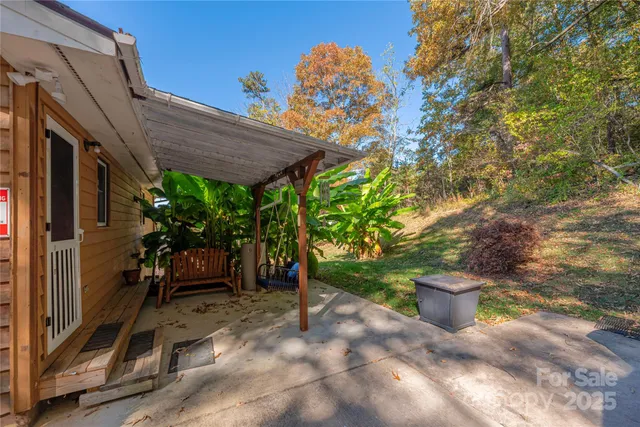 a view of a patio with table and chairs potted plants with wooden fence
