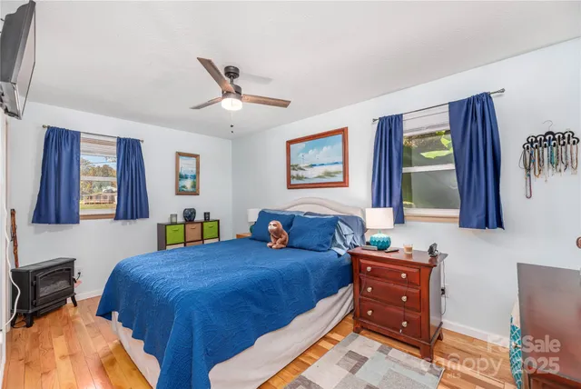 a bedroom with a bed and dresser with mirror