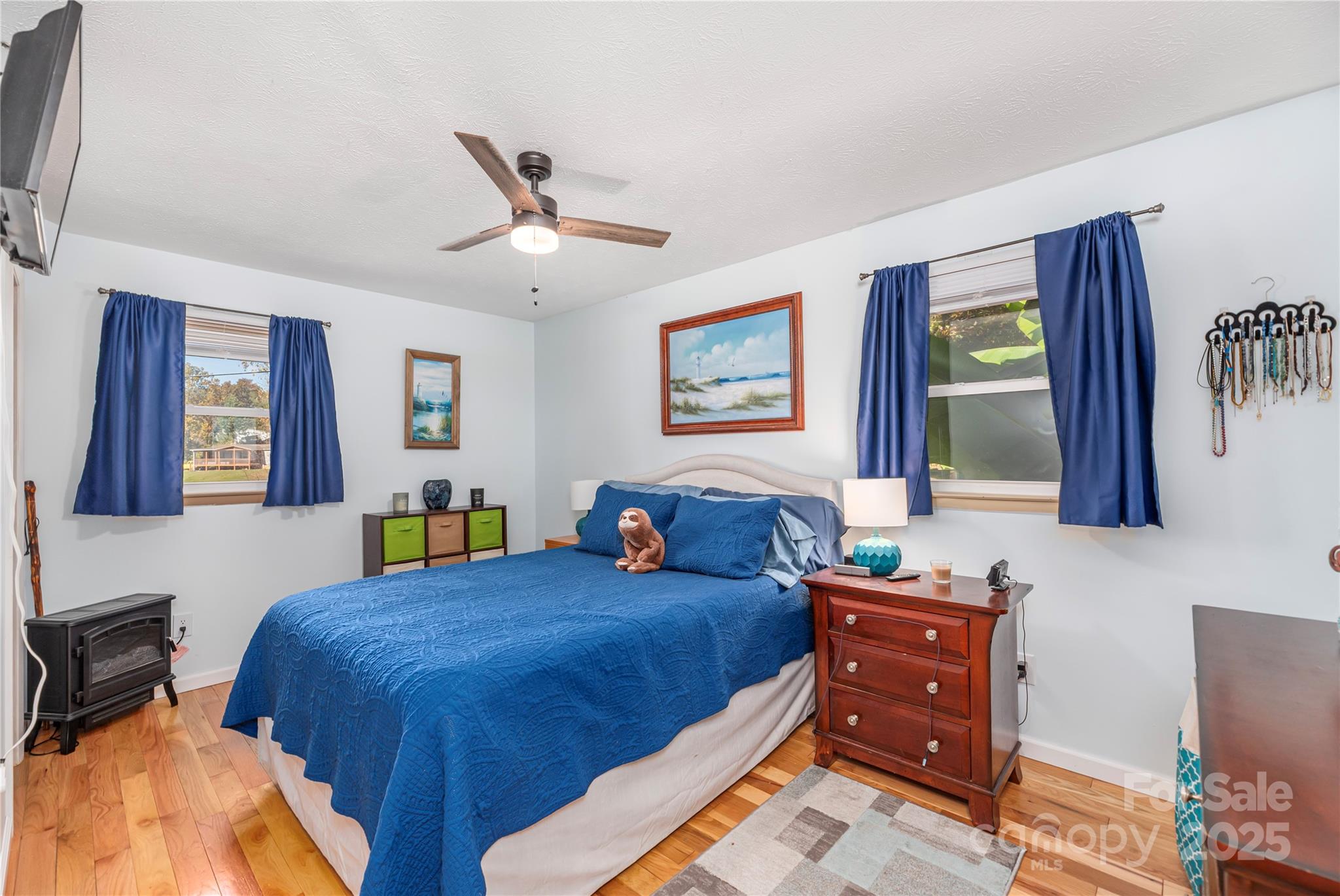 29 Arrowhead Street Clyde, NC 28721 - Photo 8 of 18 a bedroom with a bed and dresser with mirror