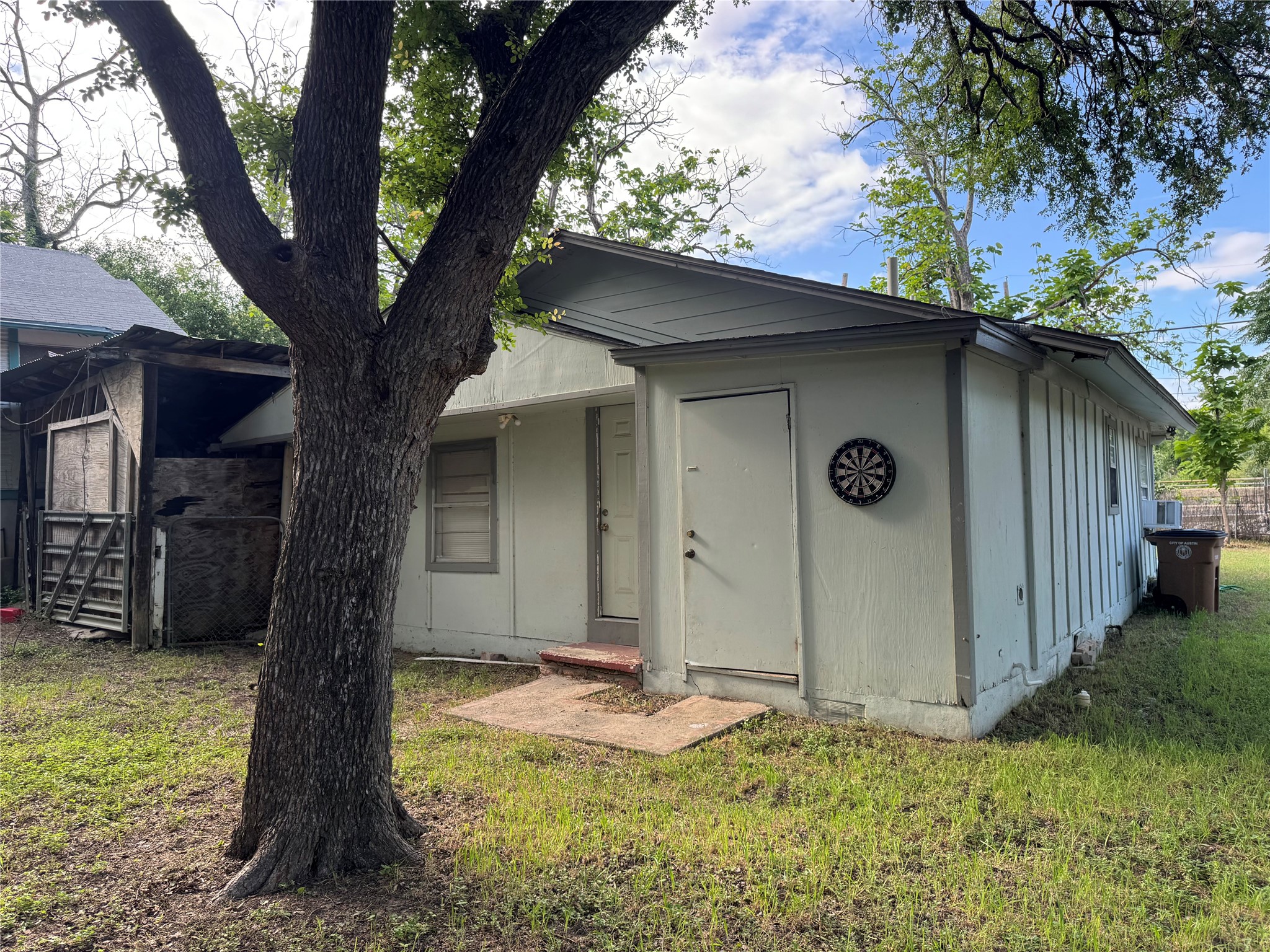 5007 Heflin Lane Austin, TX 78721 - Photo 22 of 25 Mature trees and a simple exterior define this functional rear-yard structure.